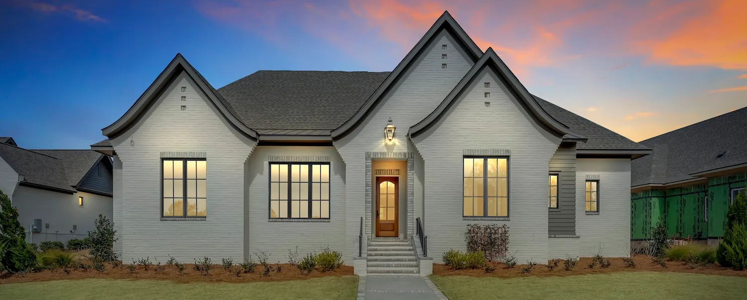 Custom coastal home built by Point Clear Building Company at dusk